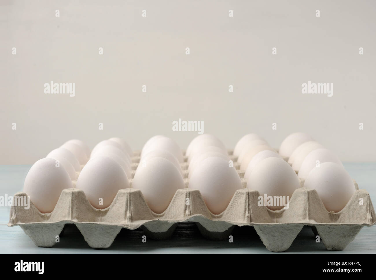Thirty fresh eggs in paper tray . Trays are usually used to store fresh eggs from farms or at farmers markets. Stock Photo