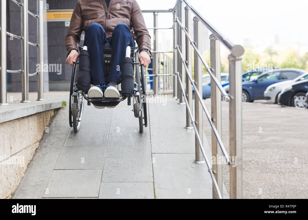 Man in a wheelchair use a wheelchair ramp Stock Photo - Alamy