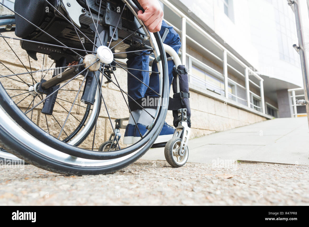 Man in a wheelchair use a wheelchair ramp Stock Photo - Alamy