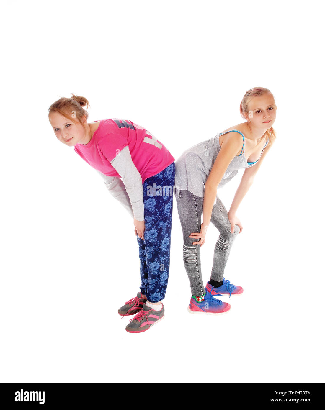 Two sisters standing butt on butt Stock Photo Alamy