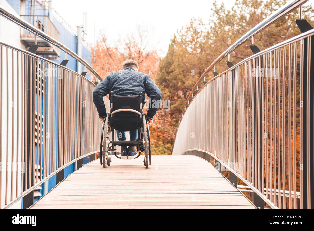 Man in a wheelchair use a wheelchair ramp Stock Photo - Alamy