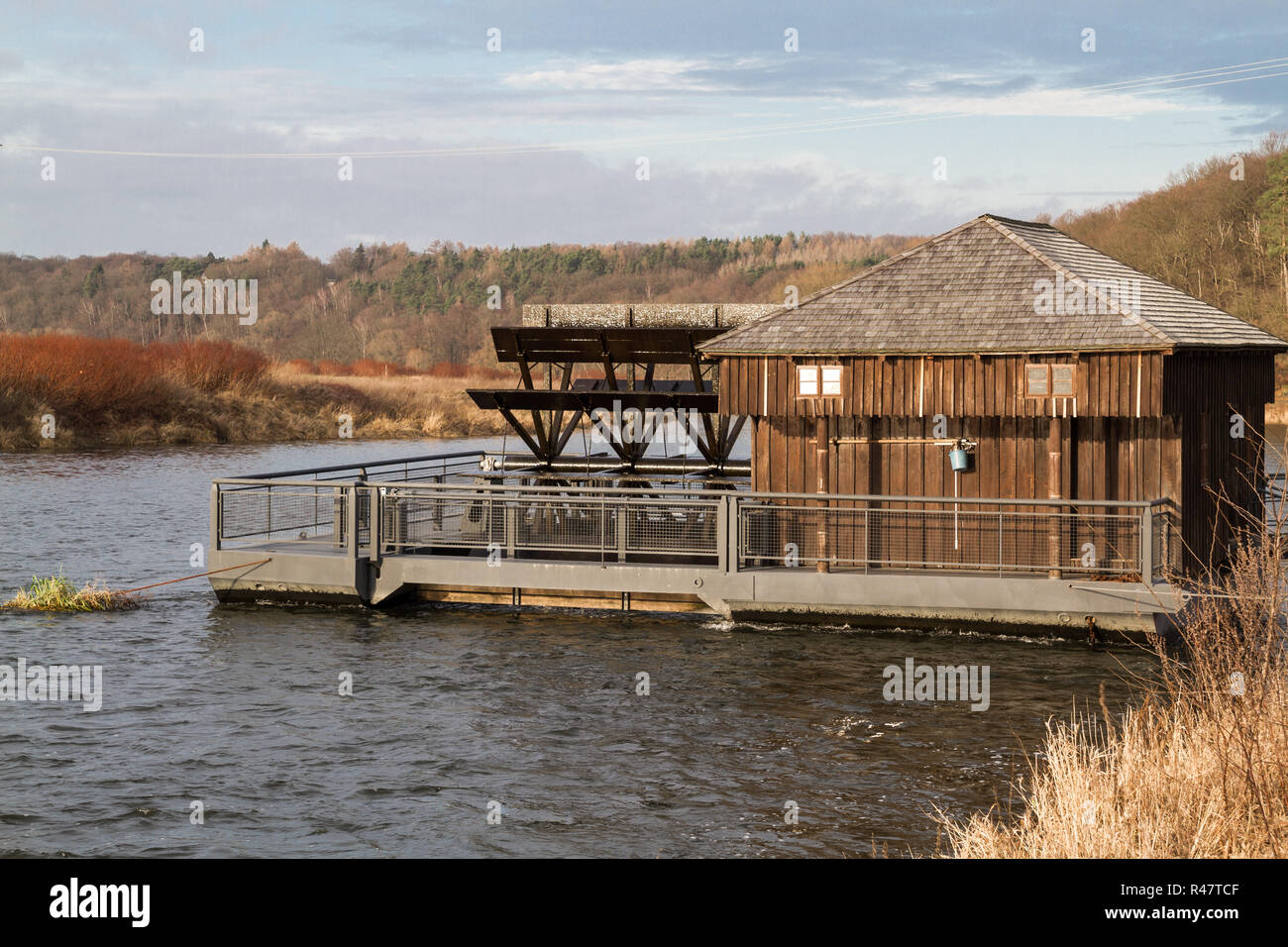 pontoon with water wheel to generate electricity at the trough Stock Photo