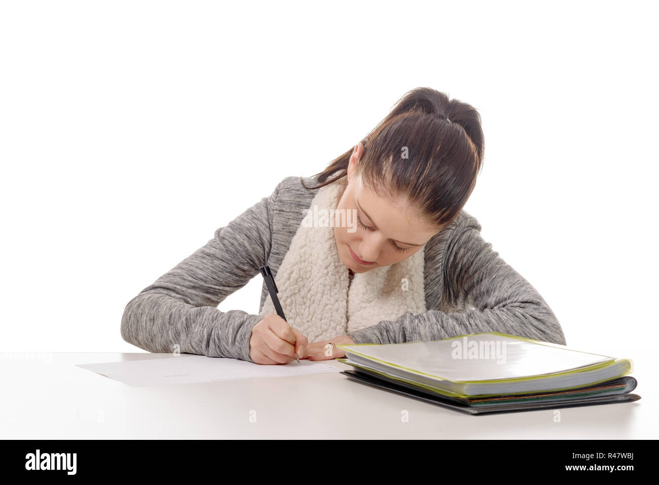 pretty young woman writing on her desk Stock Photo - Alamy