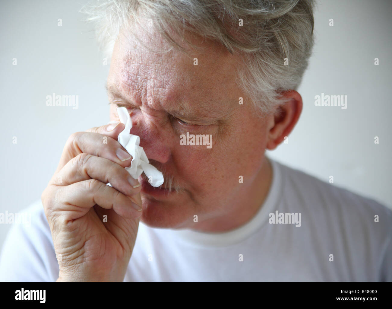 Senior man with runny nose Stock Photo Alamy