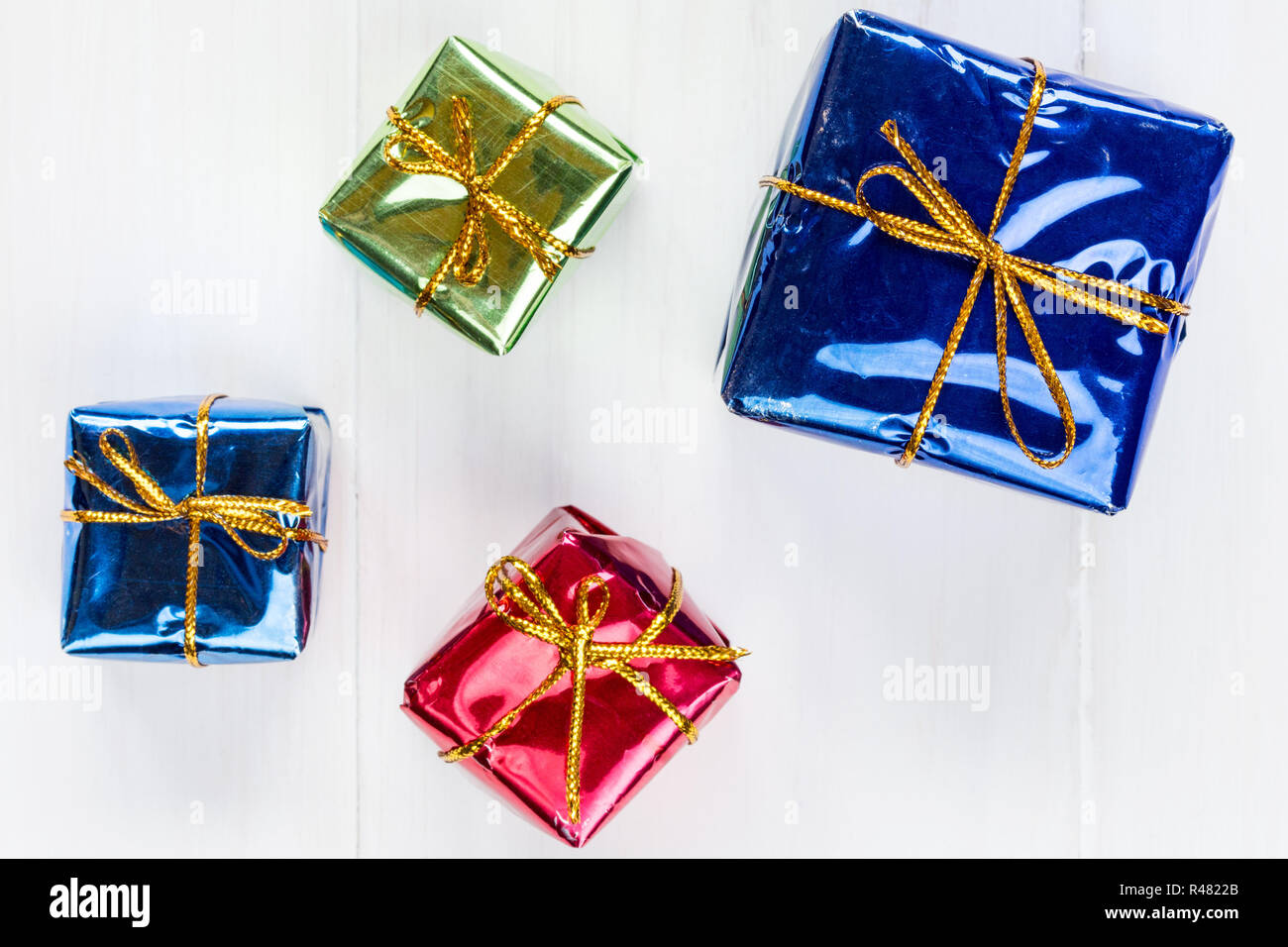 Shiny gift boxes on white wood background Stock Photo Alamy