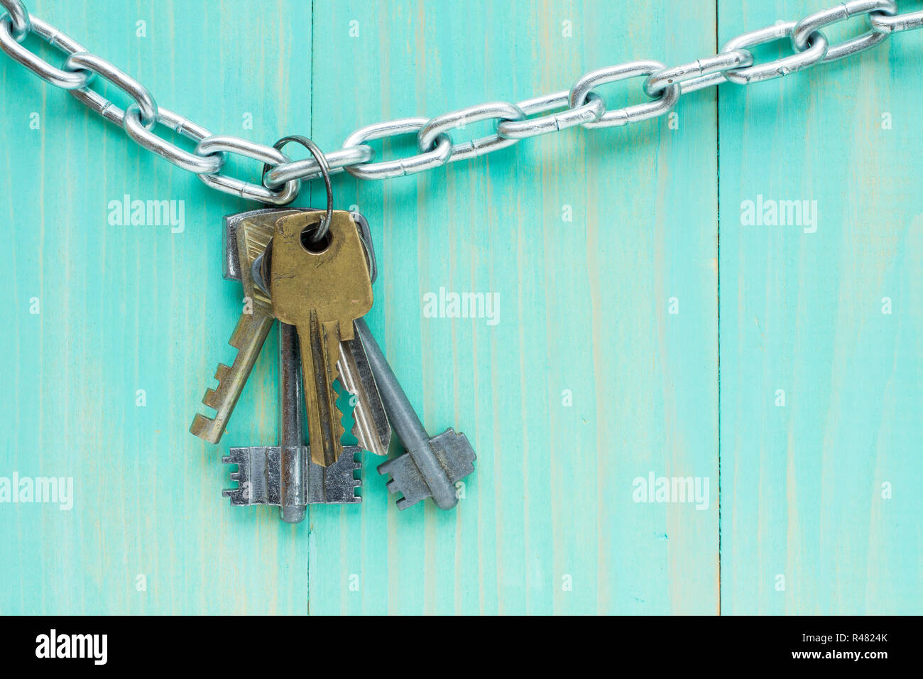 Keys hanging on blue wooden background Stock Photo
