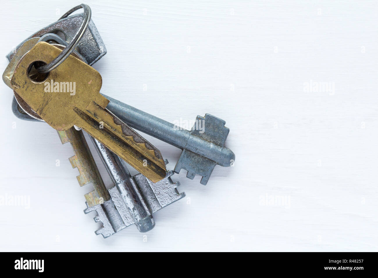 Old keys on white wooden bakground Stock Photo