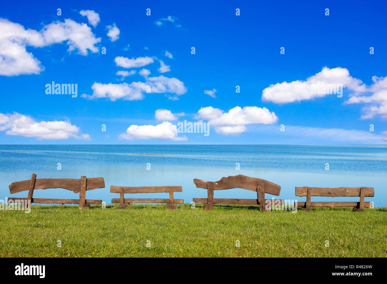 Wooden benches in front of the sea Stock Photo