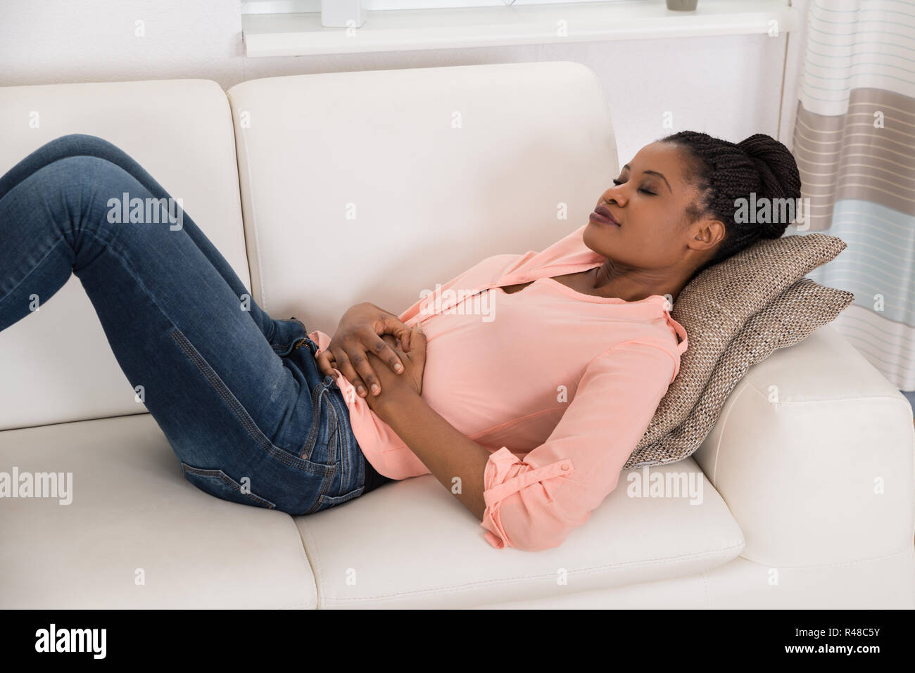 Woman Suffering From Stomach Ache Stock Photo