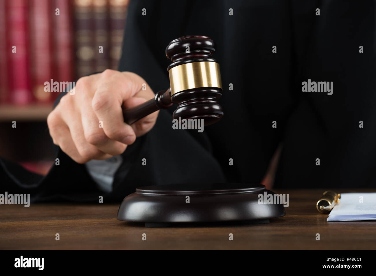 Judge Hitting Mallet At Desk Stock Photo Alamy