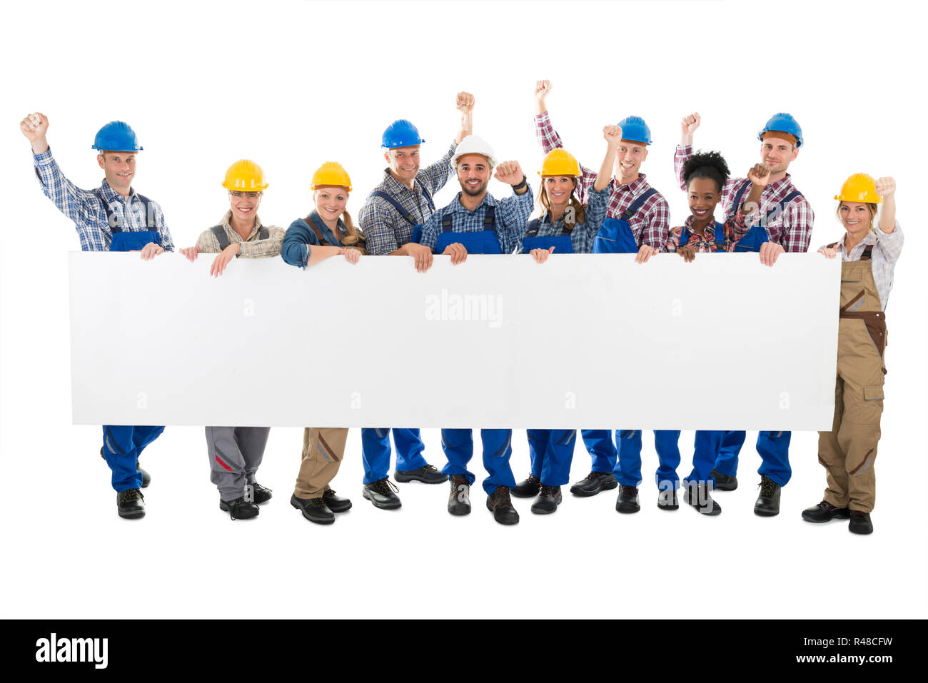 Happy Carpenters With Arms Raised Holding Blank Billboard Stock Photo