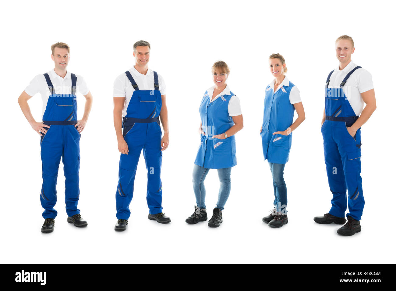 Portrait Of Confident Janitors Standing In Row Stock Photo