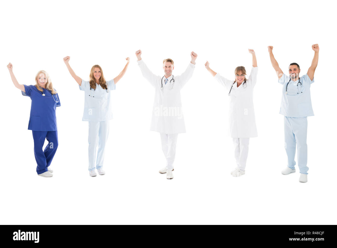 Happy Medical Team Standing With Arms Raised Stock Photo