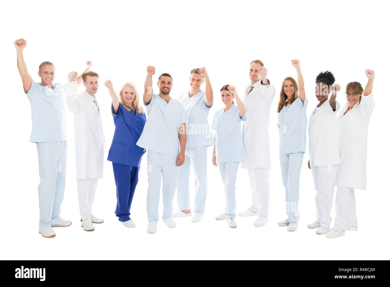 Multiethnic Medical Team Standing With Arms Raised Stock Photo