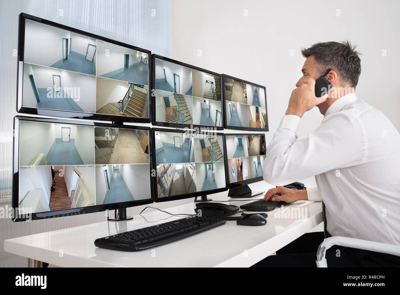 Security System Operator Looking At CCTV Footage Stock Photo Alamy