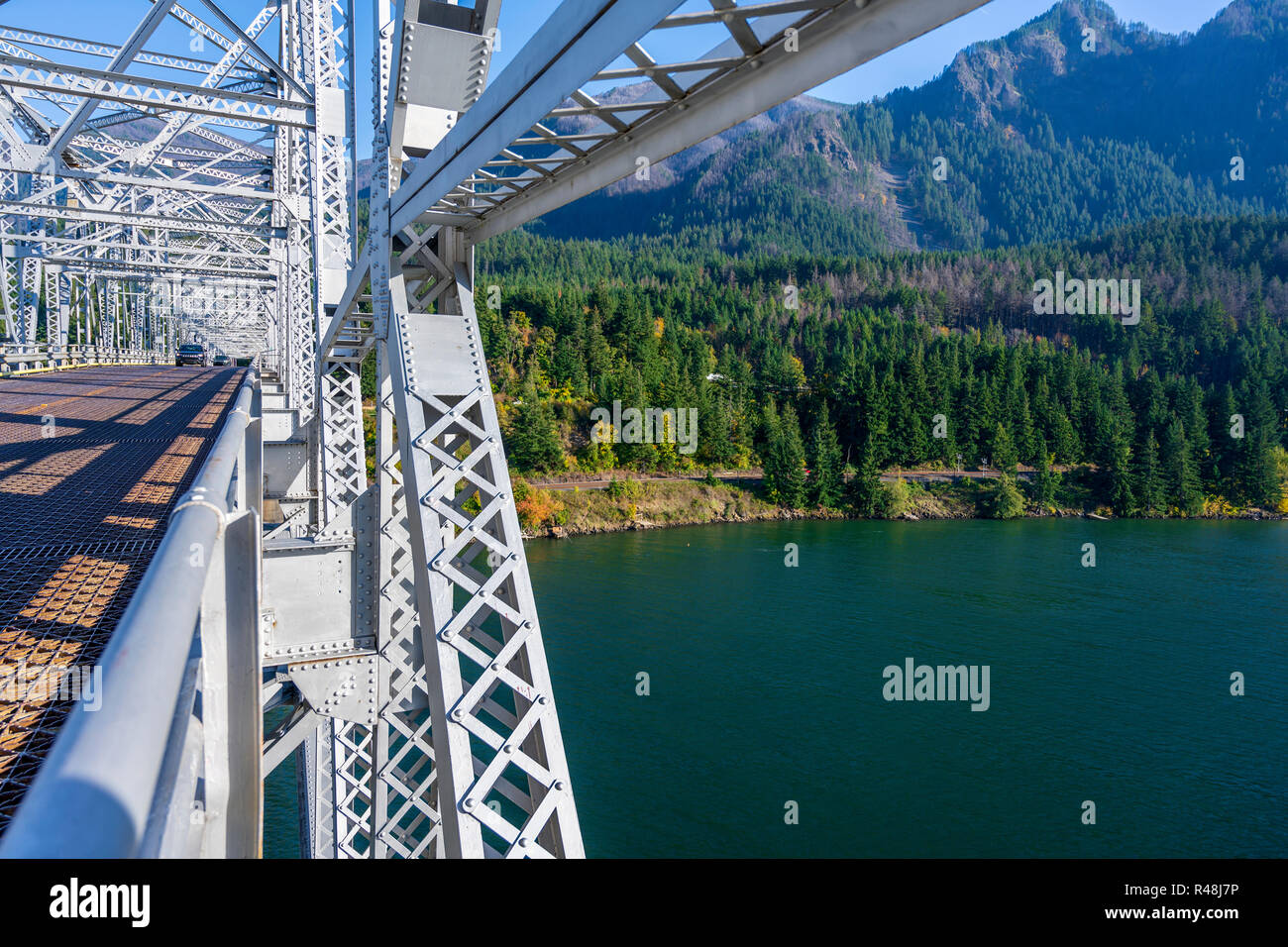 The truss Bridge of God over the Columbia River is located in a picturesque area of Columbia Gorge with hills and rocky mountains forest covered - an  Stock Photo