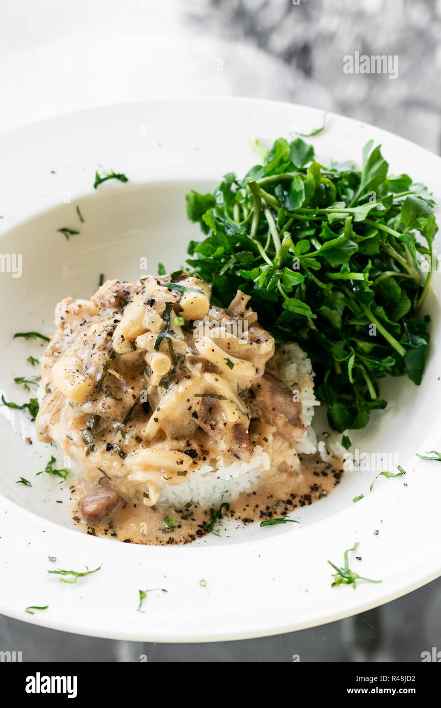 Pork Stroganoff with mushroom cream and paprika sauce gourmet meal in restaurant Stock Photo