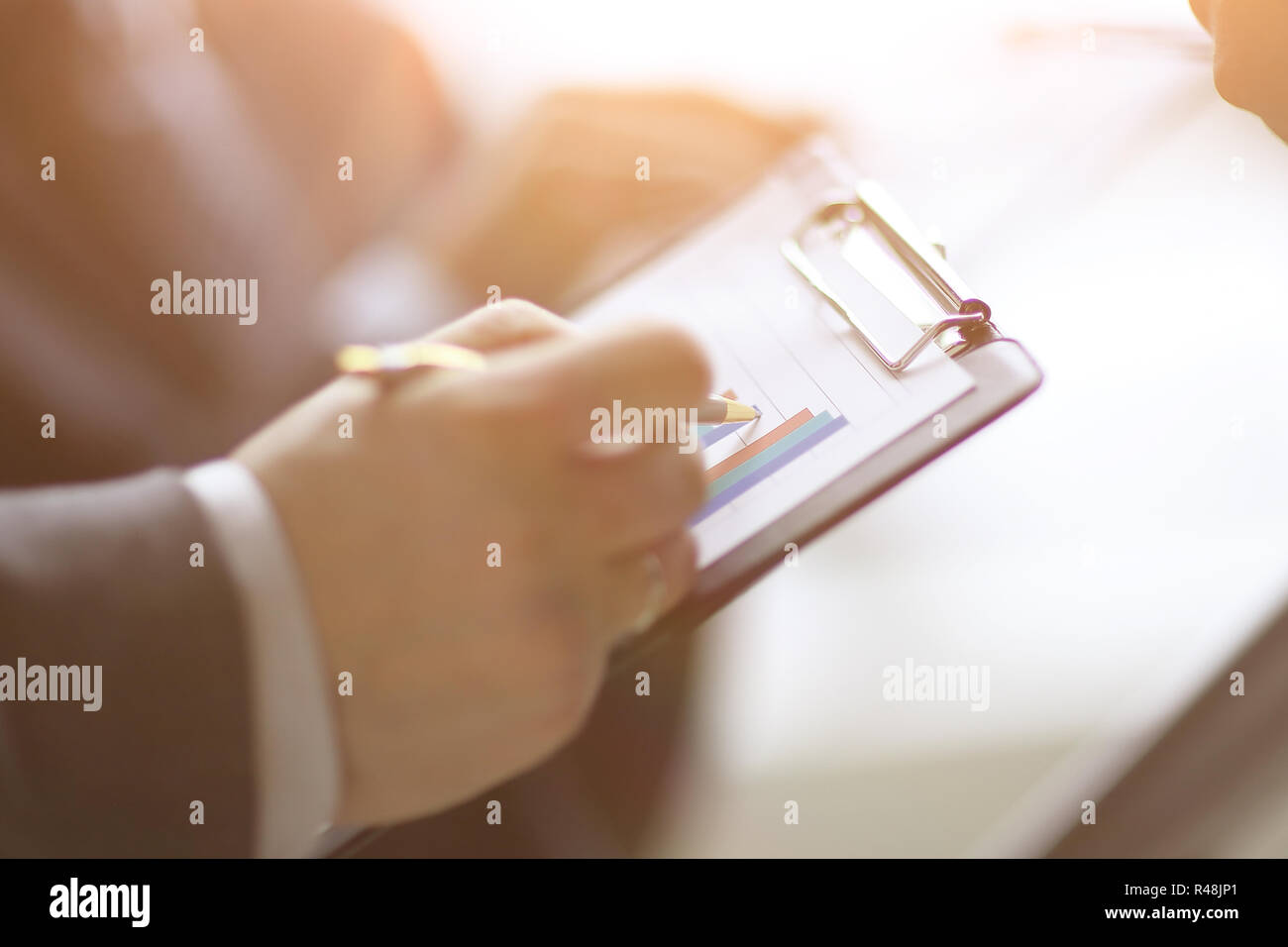 Businessman At Desk Checking A Financial Report And Pointing At A