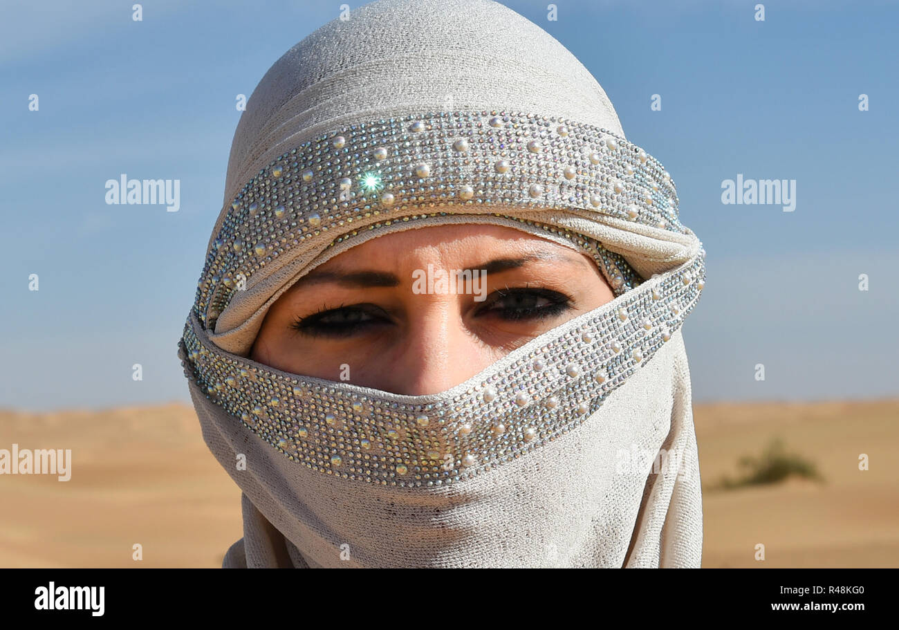 woman with veil in the desert Stock Photo