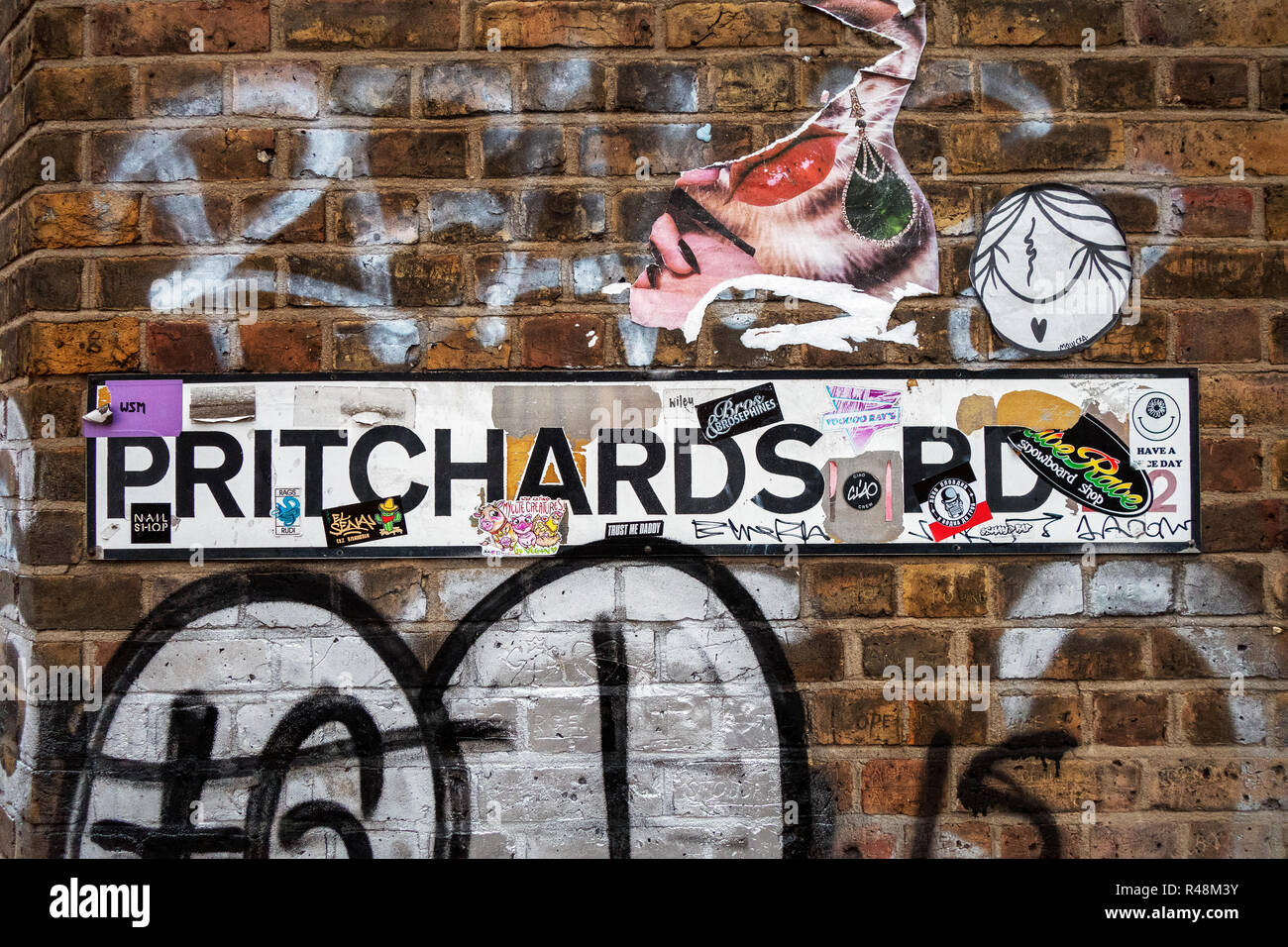 Graffiti and stickers covering Pritchards Road street sign in