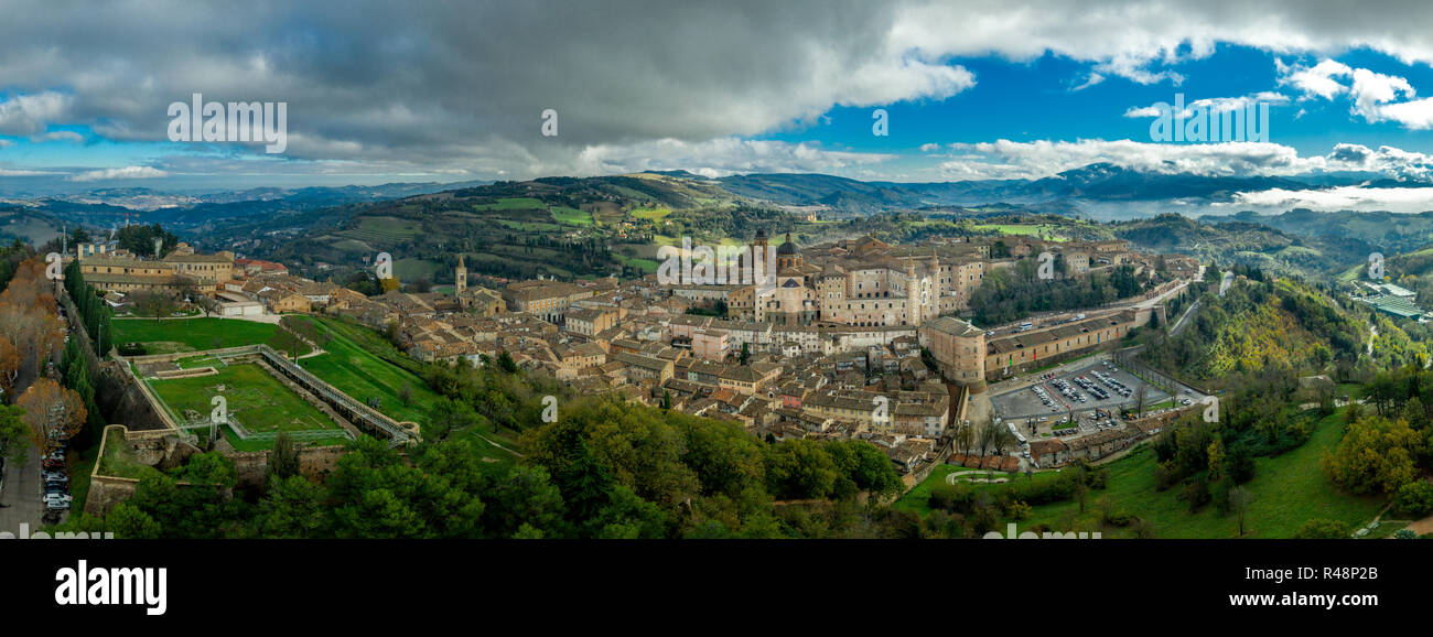 Aerial view of the medieval walled city of Urbino with ducal palace, Gothic Roman Catholic Cathedral, city walls, gates and university in Marche Italy Stock Photo