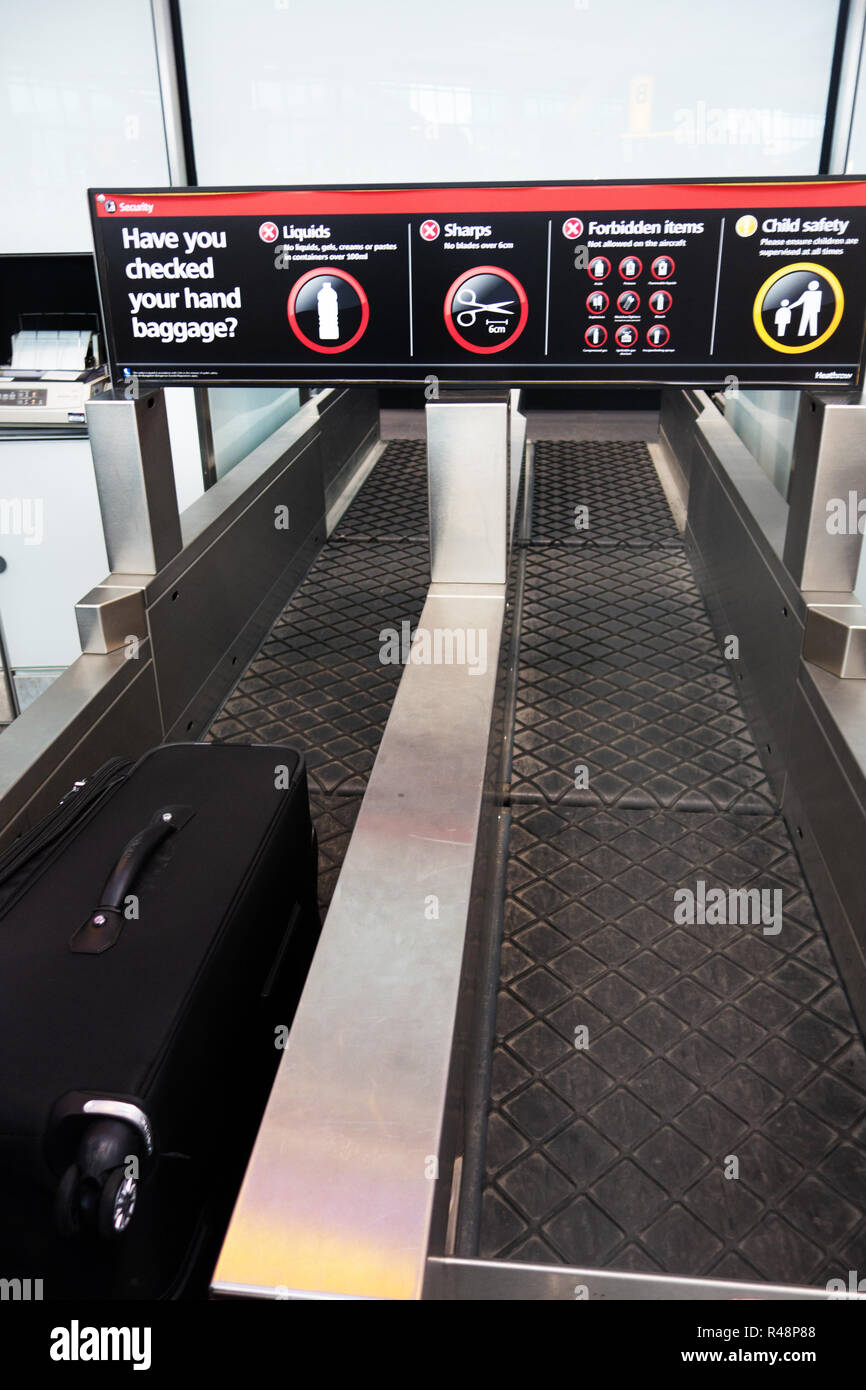 Suitcase on the Checkin conveyor belt at Heathrow Airport