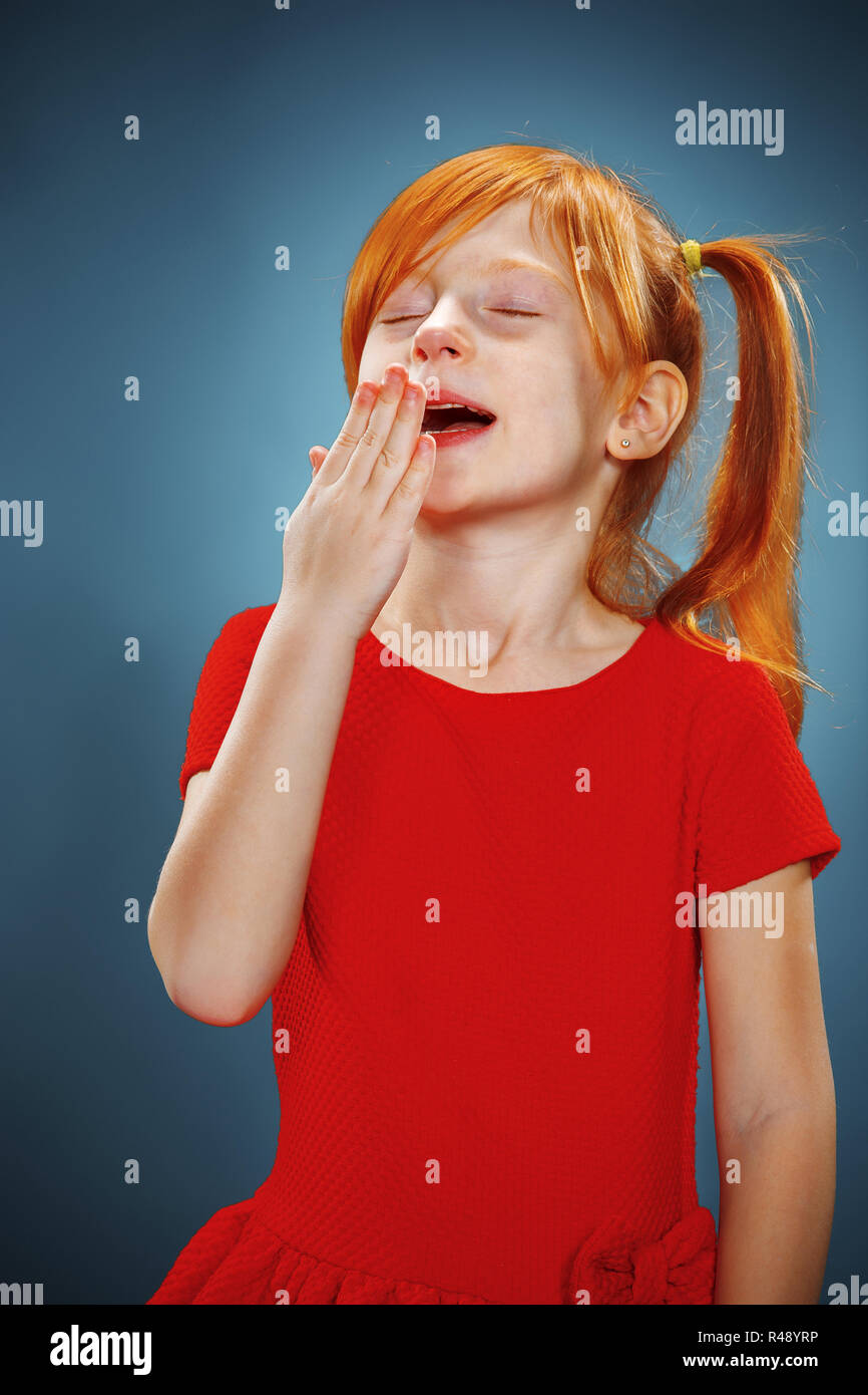 Beautiful portrait of a little yawning girl Stock Photo