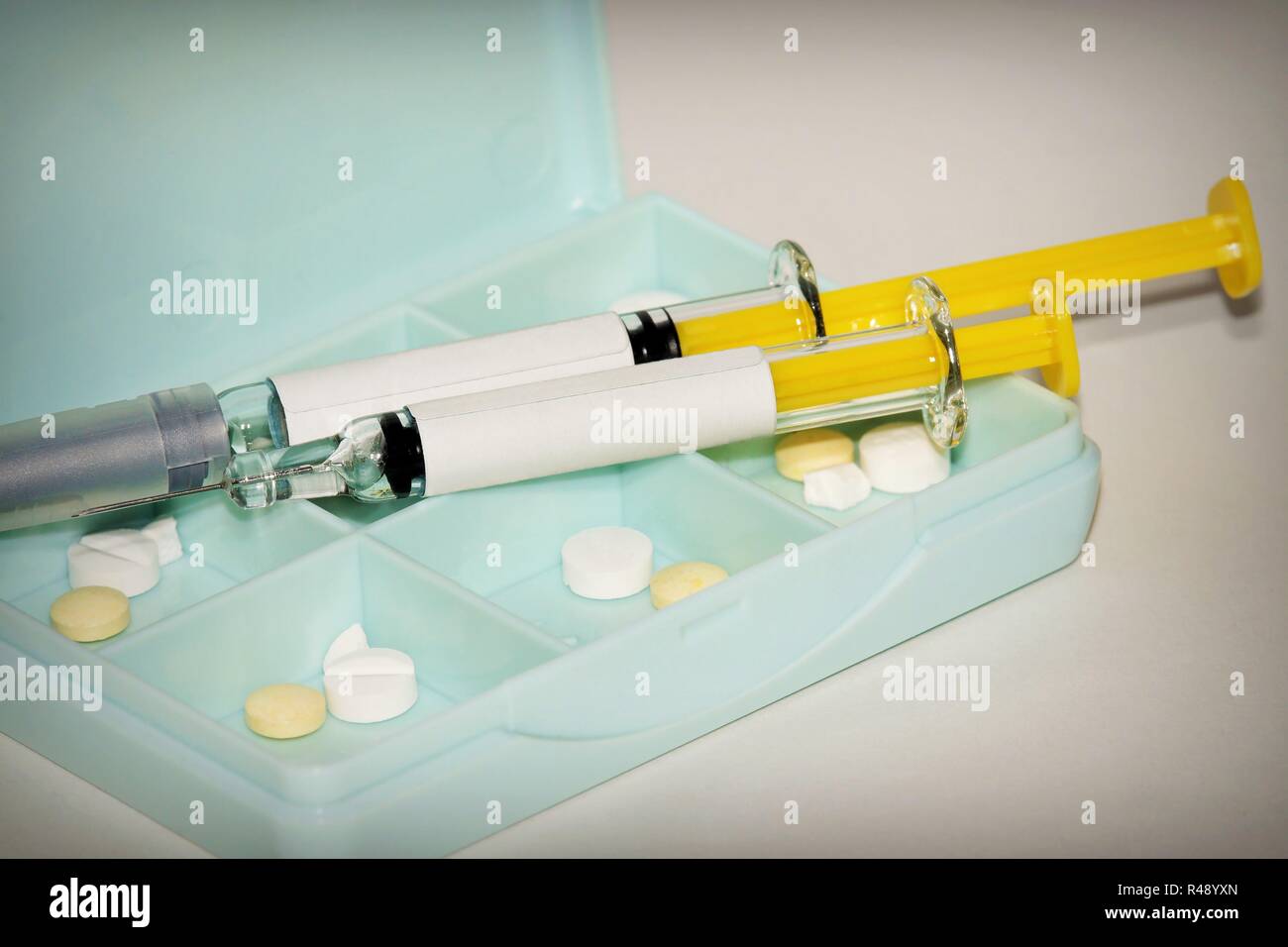 syringe and tablets on white background Stock Photo