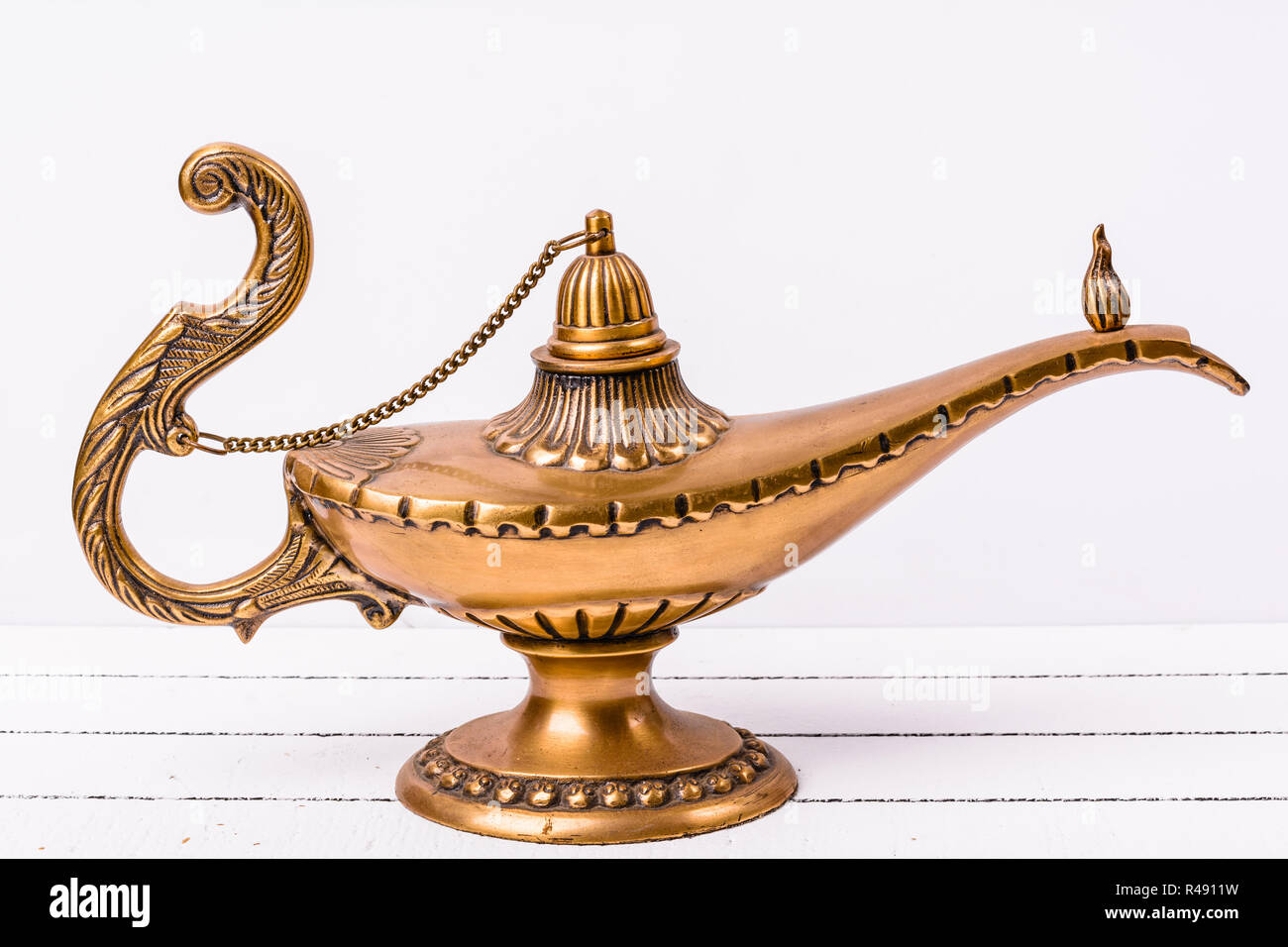 Aladdin magic lamp on white wooden background Stock Photo