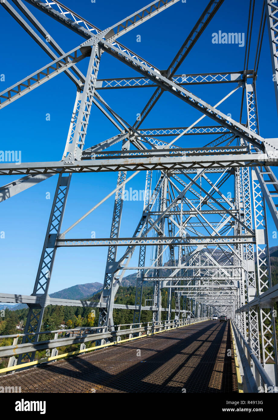 The truss Bridge of God over the Columbia River is located in a picturesque area of Columbia Gorge with hills and rocky mountains forest covered - an  Stock Photo