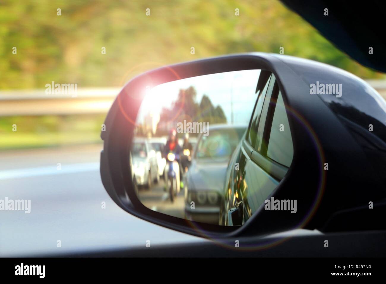 Car side mirror view with sunlight glare Stock Photo Alamy