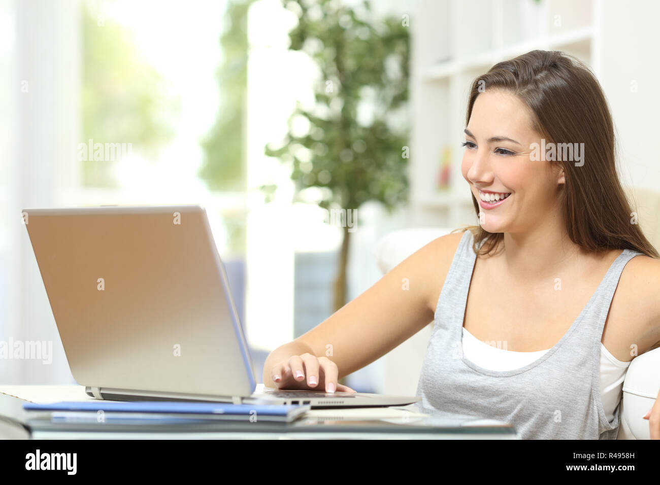 Casual woman using a laptop at home Stock Photo