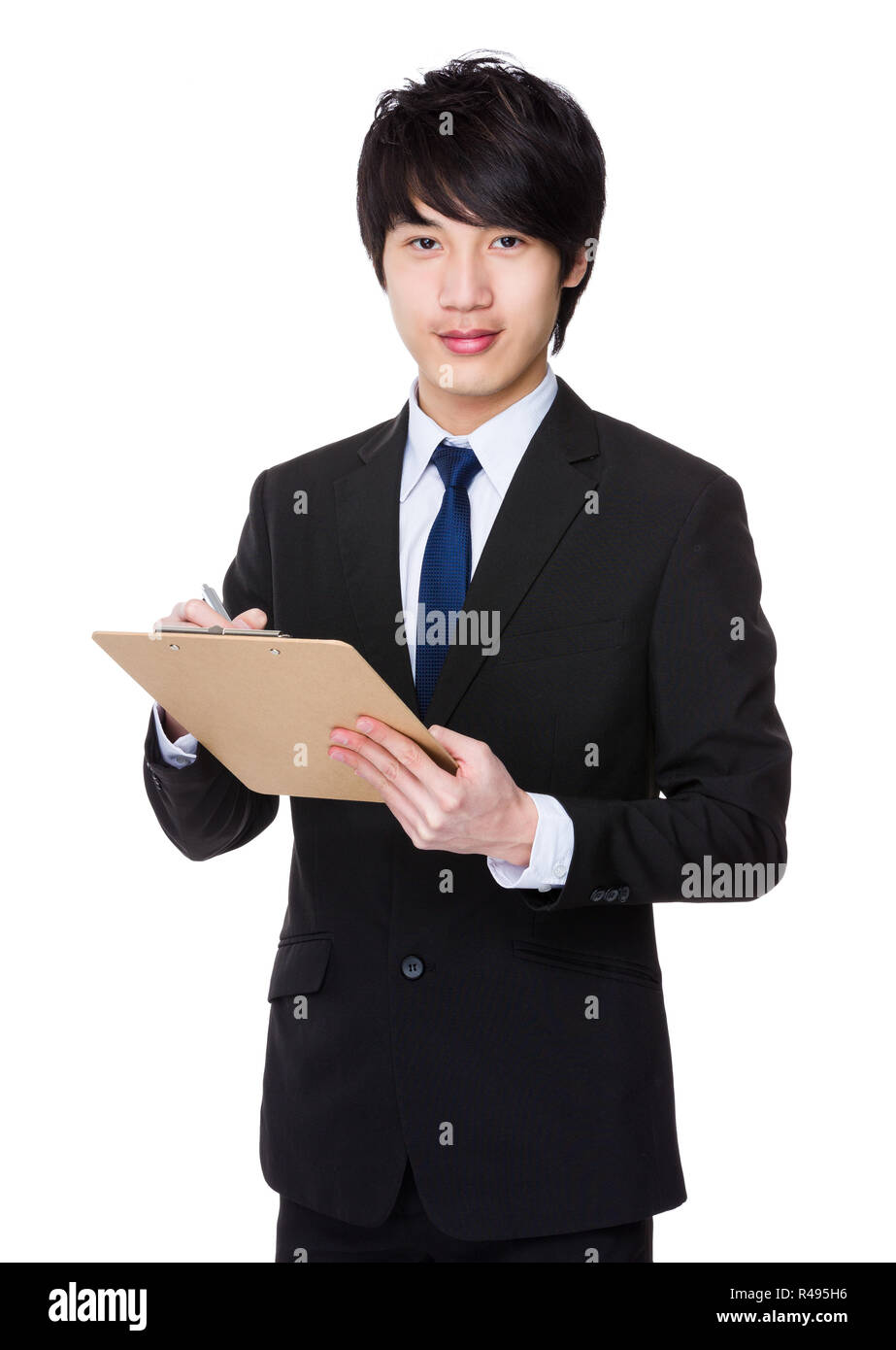 Asian businessman write on clipboard Stock Photo - Alamy