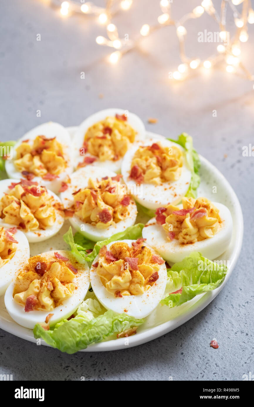 Healthy Deviled Eggs as an Appetizer with Bacon Stock Photo