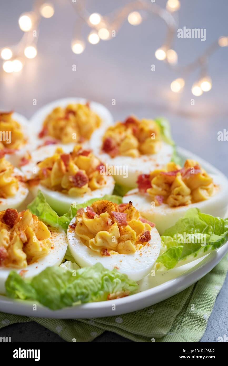 Healthy Deviled Eggs as an Appetizer with Bacon Stock Photo