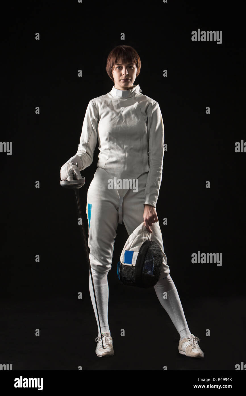 The portrait of woman wearing white fencing costume on black Stock