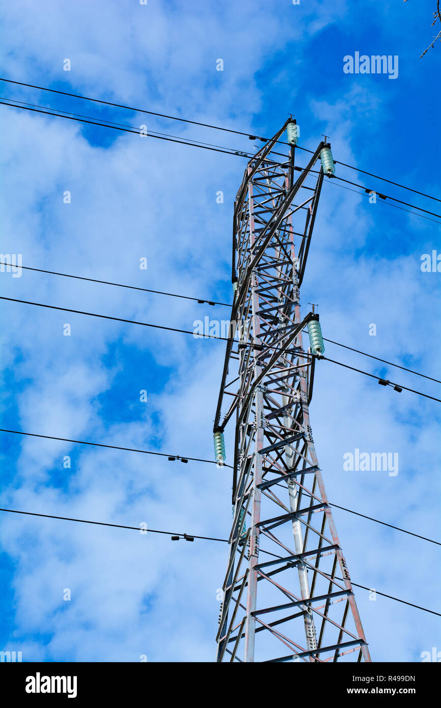 Power pole with high voltage against the blue sky Stock Photo - Alamy
