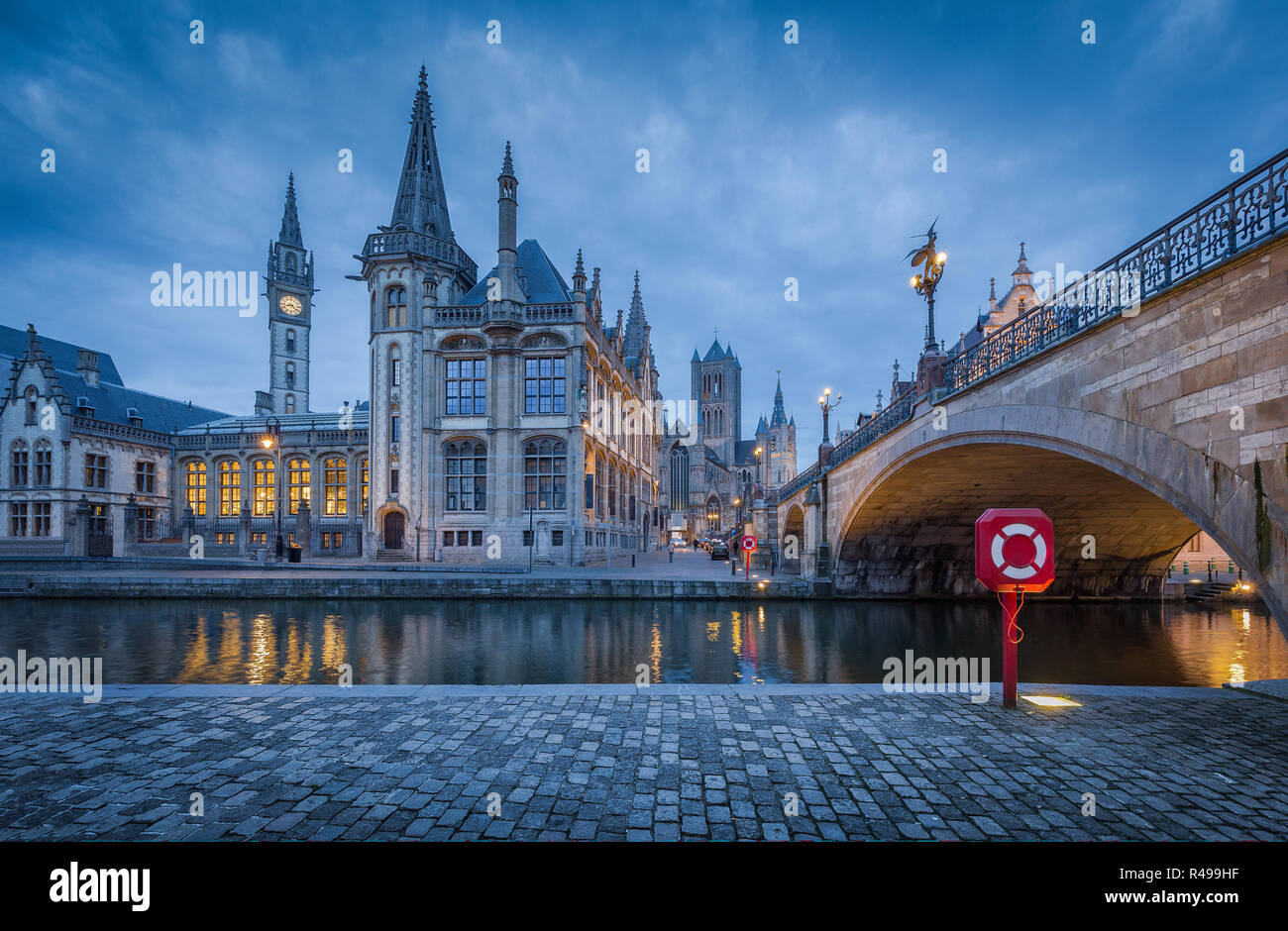 Famous Graslei in the historic city center of Ghent illuminated in beautiful post sunset twilight during blue hour at dusk, Flanders region, Belgium Stock Photo