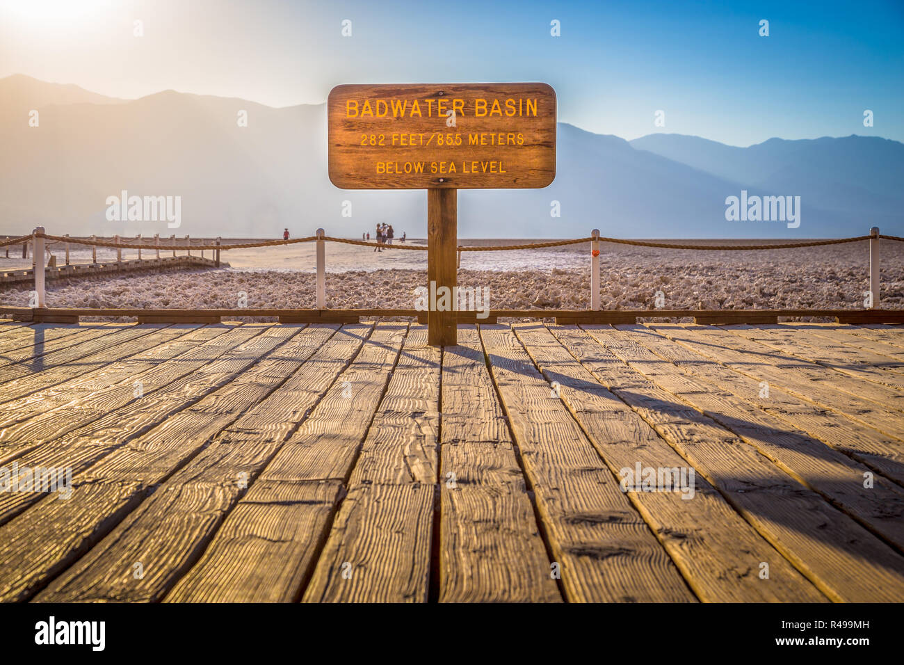 Wooden sign at famous Badwater Basin, the lowest point in North America with a depth of 282 ft (86 m) below sea level, at sunset, Death Valley Nationa Stock Photo
