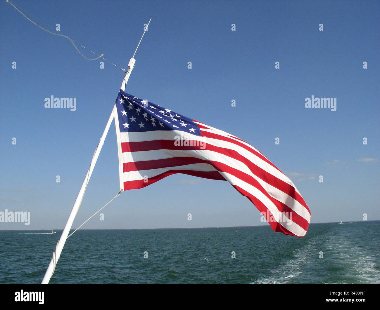 us flag at the stern of the running boat Stock Photo Alamy