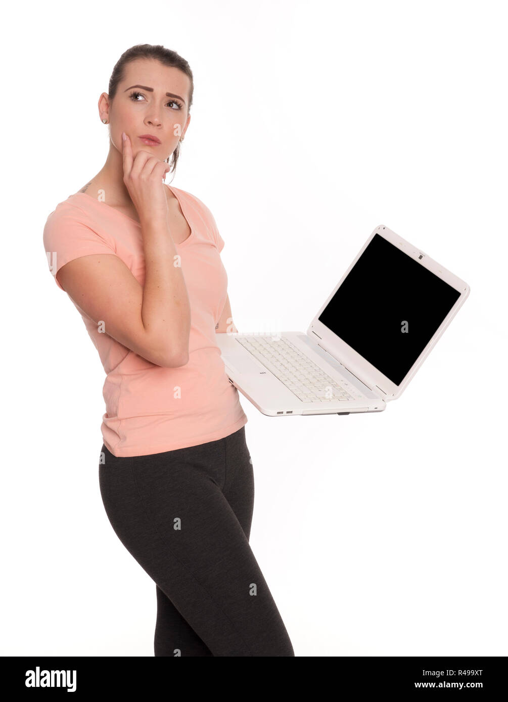 young woman at the laptop looks thoughtful Stock Photo
