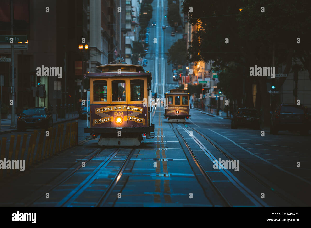 Magical twilight view of historic Cable Cars riding on famous California Street at dawn before sunrise, San Francisco, California, USA Stock Photo