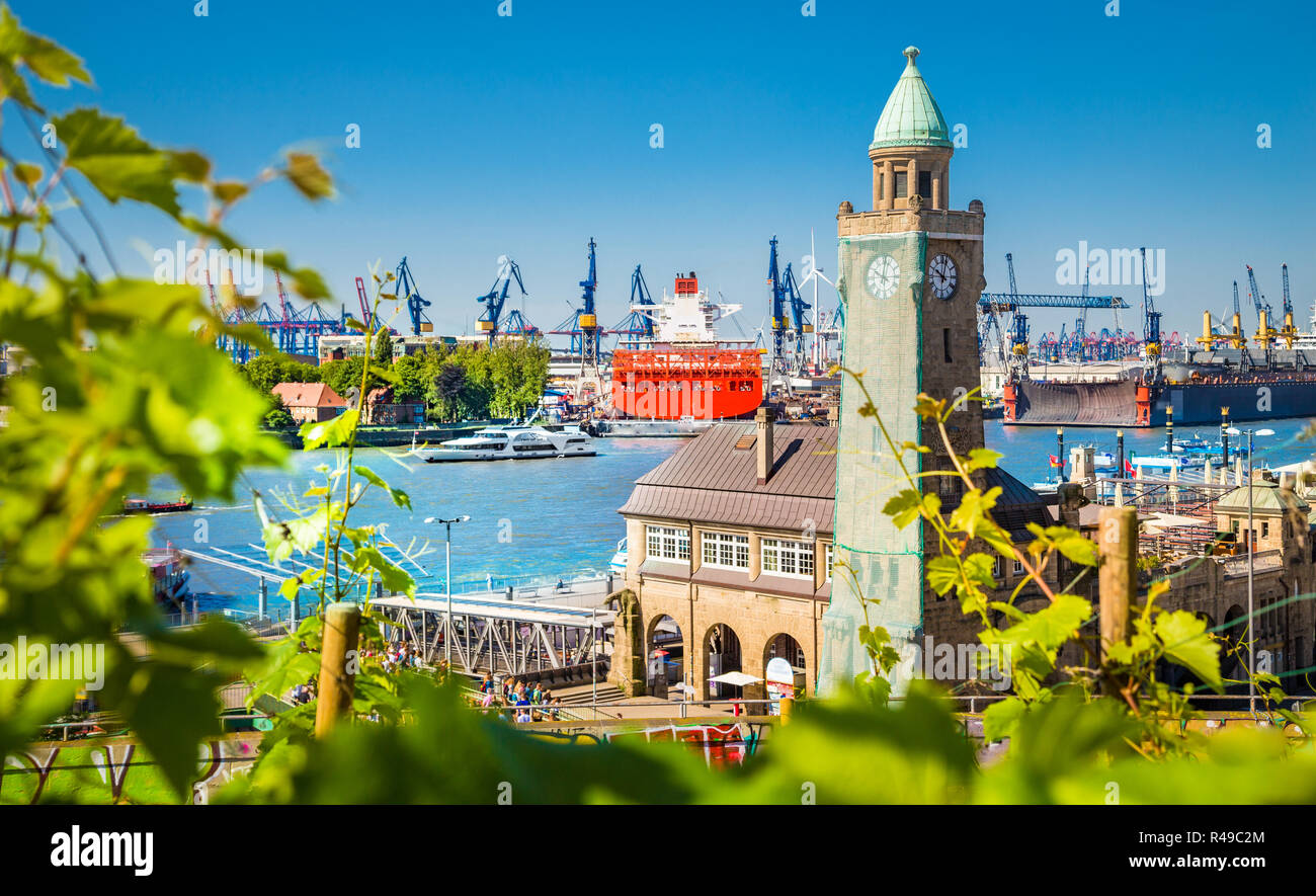 Beautiful view of famous Hamburger Landungsbruecken with commercial harbor and Elbe river with blue sky and clouds in summer, St. Pauli district, Hamb Stock Photo