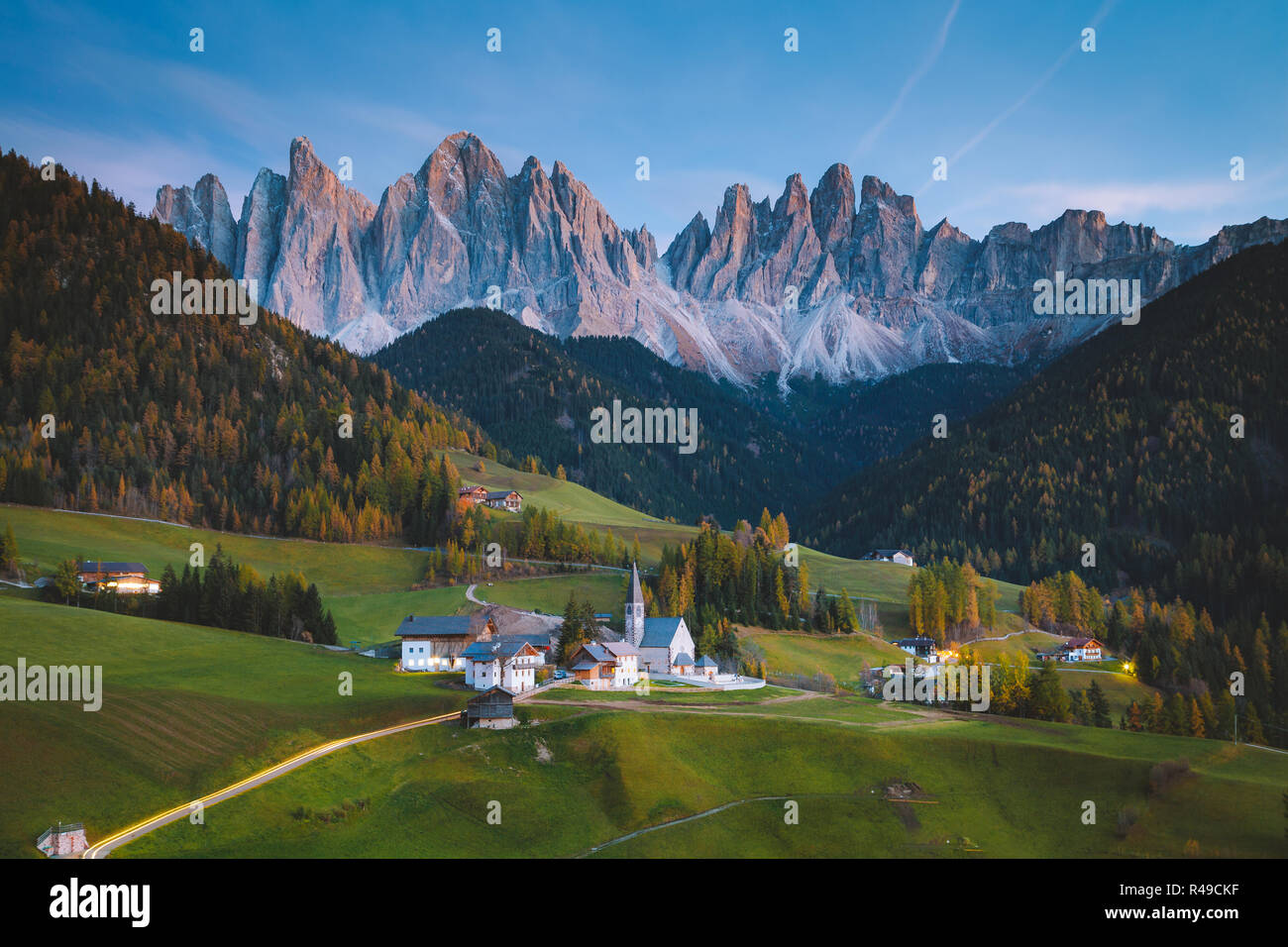 Beautiful view of idyllic mountain scenery in the Dolomites with famous Santa Maddelana village in golden evening light at sunset, South Tyrol, Italy Stock Photo