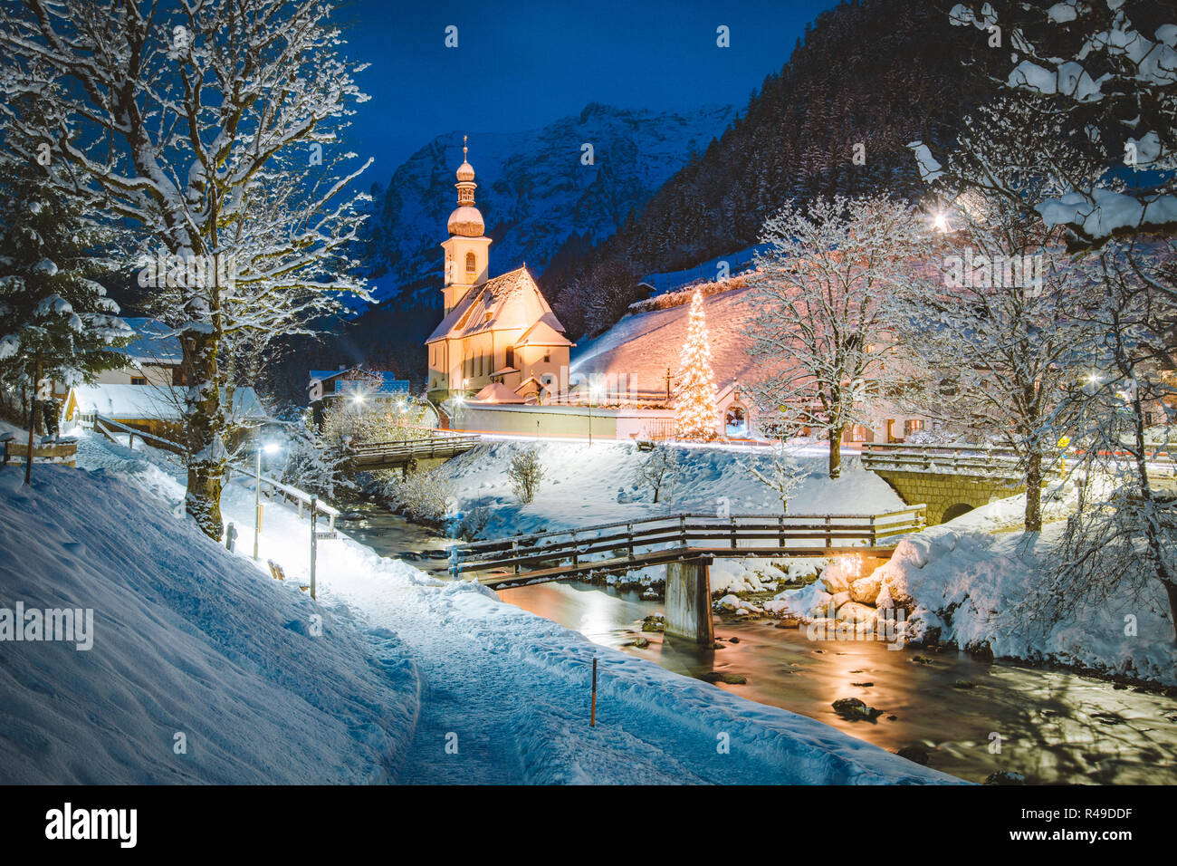 Twilight view of Sankt Sebastian pilgrimage church with decorated Christmas tree illuminated during blue hour at dusk in winter, Bavaria, Germany Stock Photo