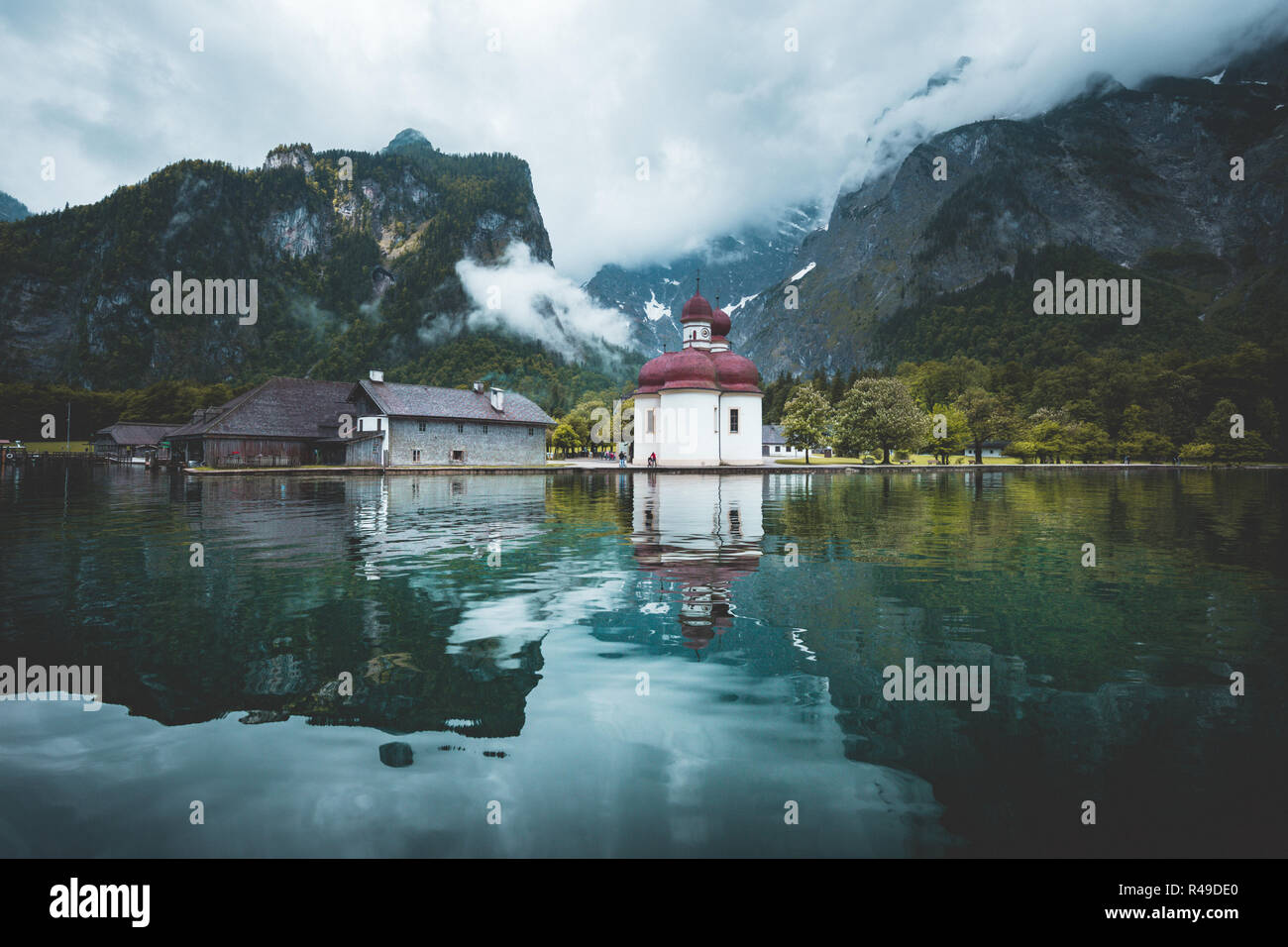 Classic panoramic view of Lake Konigssee with world famous Sankt Bartholomae pilgrimage church and Watzmann mountain on a beautiful sunny day in summe Stock Photo