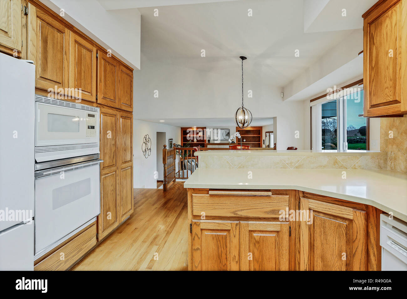 Open Large Kitchen Interior With Vaulted Ceiling And White