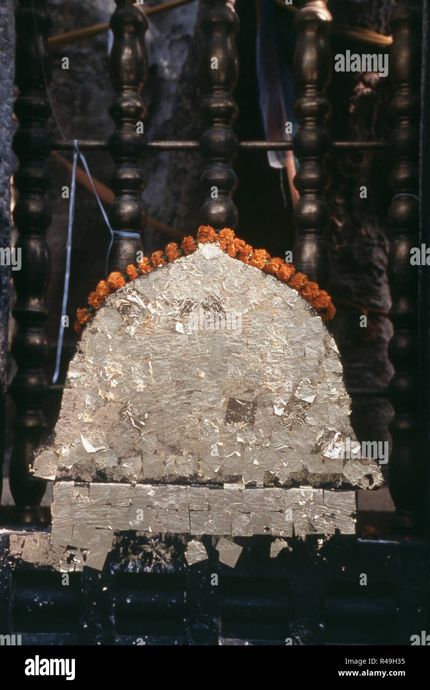 Holy stone with thin gold plate, Bodh Gaya, Bihar, India, Asia Stock Photo