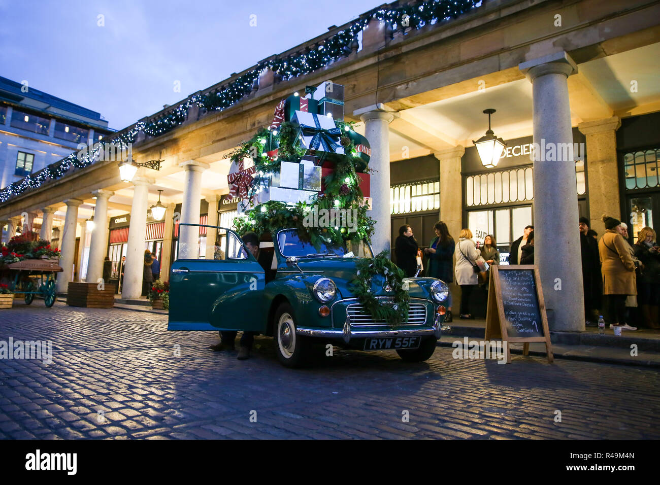 A Classic car decorated with Christmas presents is seen in Covent Gardens. Stock Photo