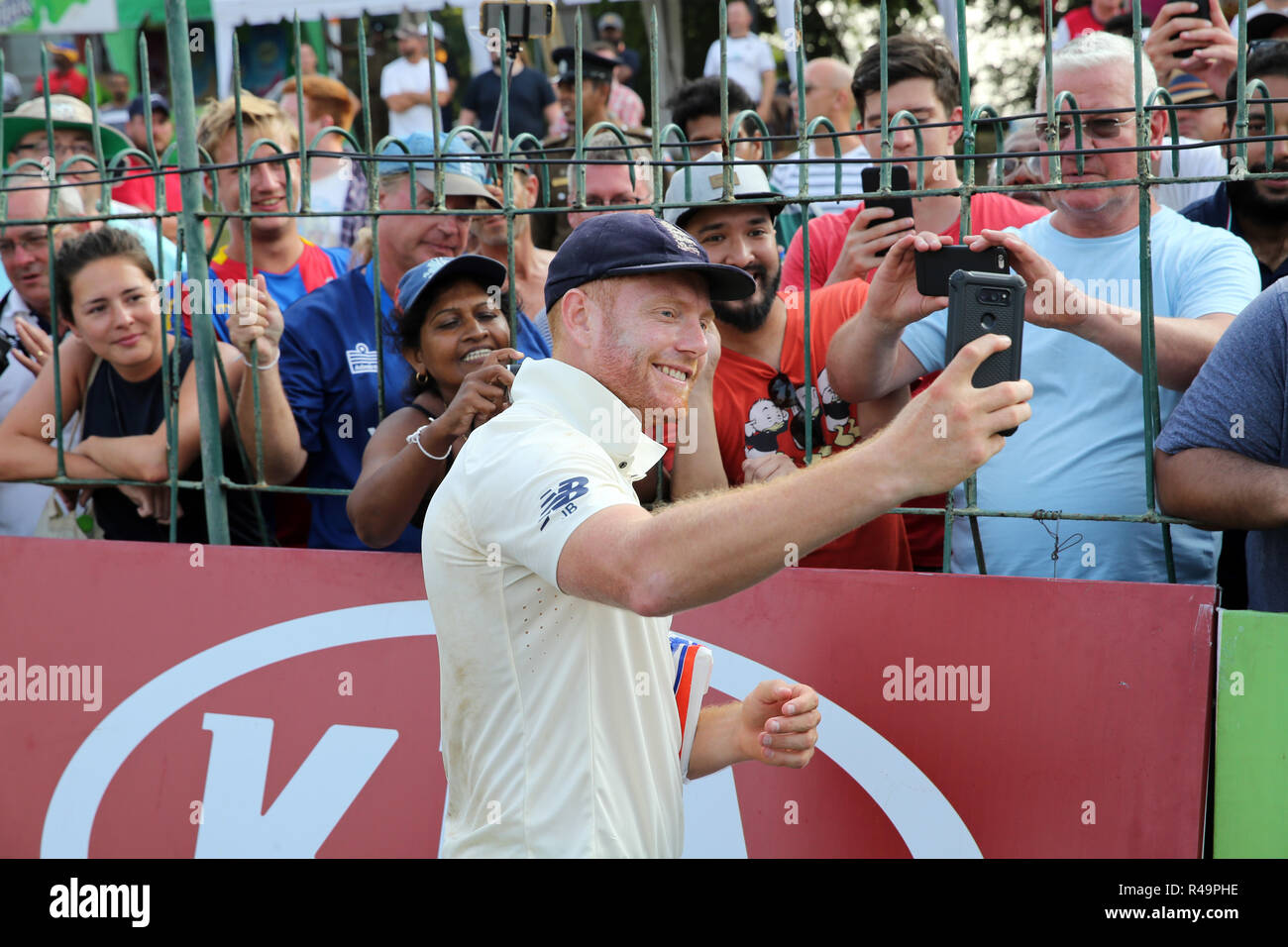 Colombo, Sri Lanka. 26th November 2018, Sinhalese Sports Club Ground, Colombo, Sri Lanka; International Test Cricket, third test, day 4, Sri Lanka versus England; Jonny Bairstow takes a selfie with one of the fans phones as England win the series Credit: Action Plus Sports Images/Alamy Live News Stock Photo